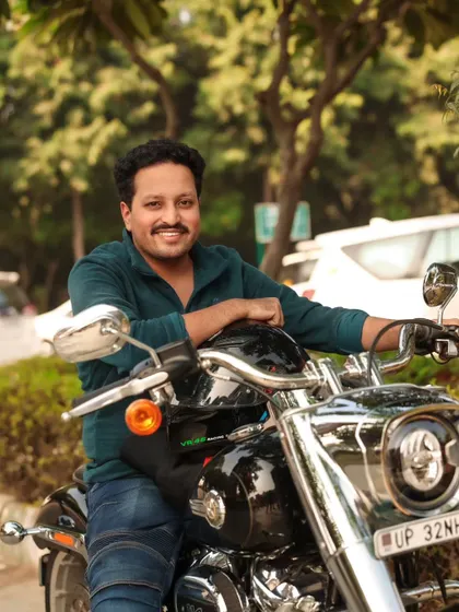 A close-up portrait of the rider, capturing his friendly smile and relaxed demeanor.