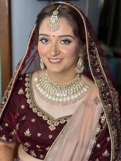 A classic bridal portrait. The makeup is perfectly set with a dupatta, showcasing a look that is both traditional and chic.