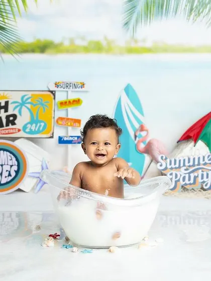 Another angle of our fun beach party tub session. This little one is enjoying his milk bath surrounded by all the essentials for a day at the beach.