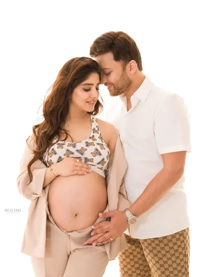 A tender embrace between an expecting couple. This intimate portrait captures the quiet connection and shared dream of their growing family.