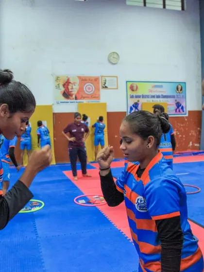 Teammates play a game of rock-paper-scissors. Small moments of fun and friendship are essential for building strong team bonds.