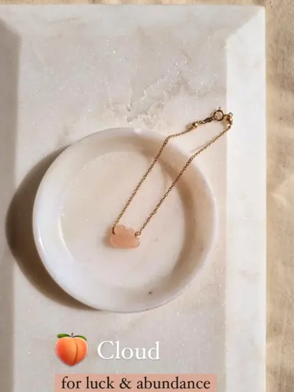 The Peach Moonstone cloud bracelet, a charm for luck and abundance.