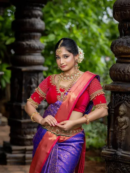 This image focuses on the upper body, giving a clear view of the necklace, jhumkas, and maang tikka.