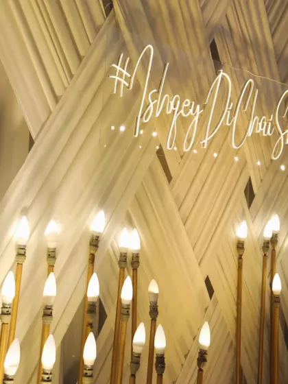 A custom neon sign with the couple's wedding hashtag, '#IshqeyDiChaiShivi', adding a modern and personal touch to the decor.