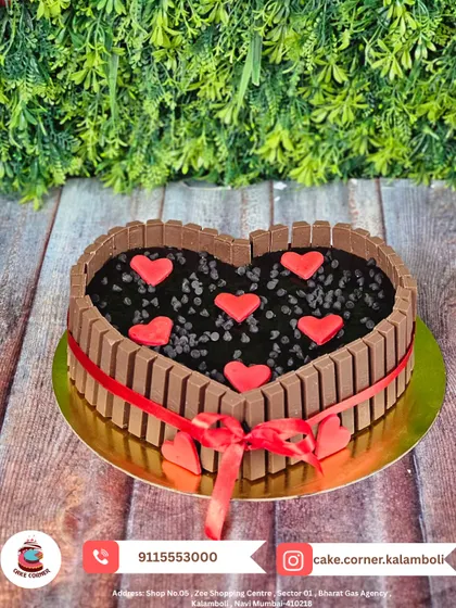A heart-shaped KitKat cake filled with chocolate chips and decorated with red hearts. A crunchy, chocolatey, and loving treat for your special someone.