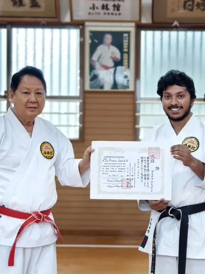 Sensei Loyd Pinto receives his Sandan (3rd Dan) certificate from Hanshi Minoru Nakazato, marking his advancement to a senior instructor level.