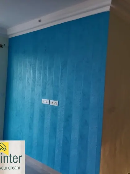 A blue accent wall with a subtle vertical striped texture. This adds a layer of detail to the color, creating a more dynamic and interesting surface.