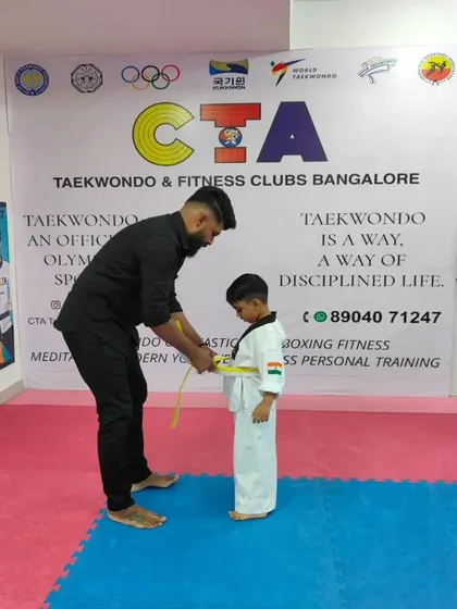 Tying a yellow belt.