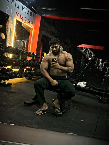 Gaining like a pro. A relaxed pose after a workout, showing the size I've put on during my bulk.