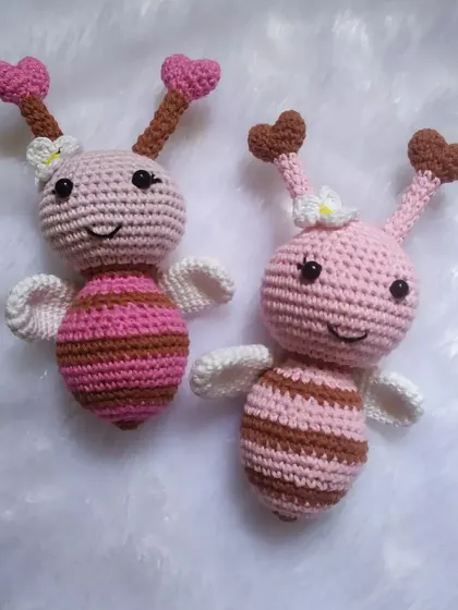 A pair of pink crochet bees, or butterflies as some people see them. You can customize these cuties in your choice of colors.