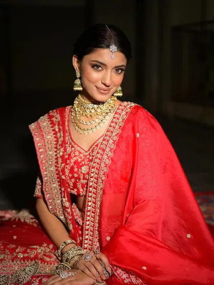 The bride looking directly at the camera, her confidence shining through. The makeup is flawless and enhances her natural beauty.