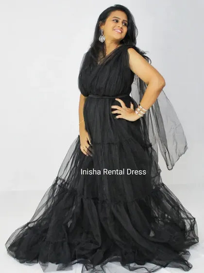 The mother's gown is a beautiful tiered black tulle dress that is both elegant and comfortable for posing with your little one.