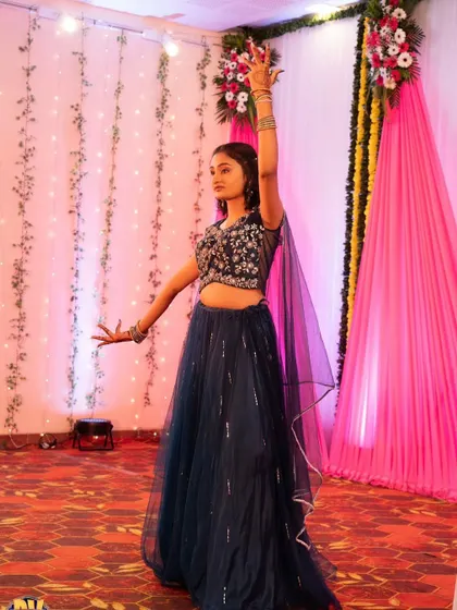 Another shot of the client dancing, showing the movement of the beautiful navy blue lehenga.