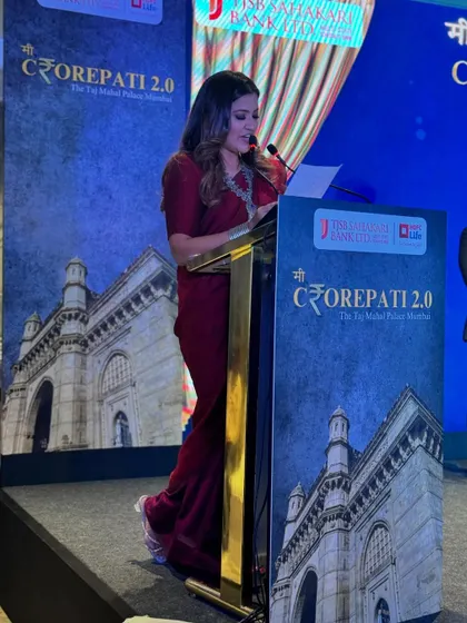 A side view from the podium, reading from my script to ensure all announcements are accurate and timely for the HDFC Life and TJSB Bank event.