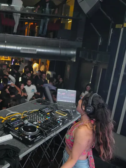 Another perspective of me commanding the decks at a multi-level venue. My experience allows me to manage the energy of both intimate pubs and large-scale clubs.