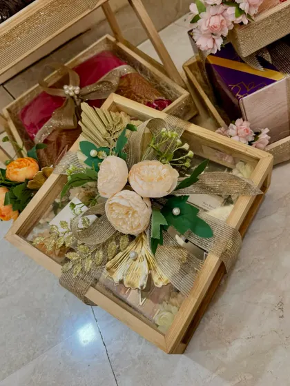 This glass-lidded wooden box is one of my favorite ways to present wedding gifts. The contents are visible, while the top is decorated with a stunning arrangement of peonies and golden leaves.