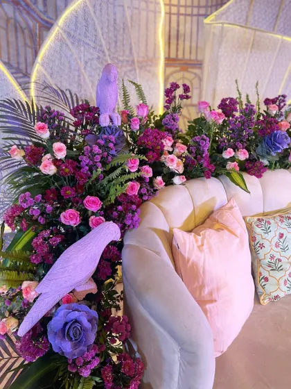 Details we love: small bird sculptures perched among the lush purple and pink florals of our 'Illuminated Garden' theme.
