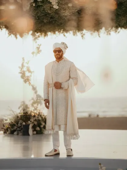 The groom looking sharp and stylish against the golden hour sunset at his Goa wedding.