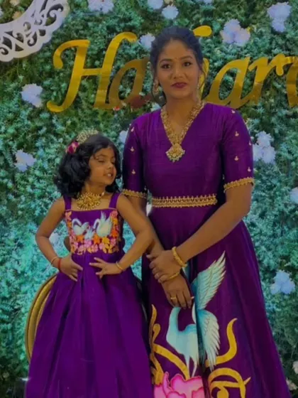 This hand-painted mom-daughter duo in matching purple gowns is one of my favorite creations. The swan motif adds a touch of artistry.
