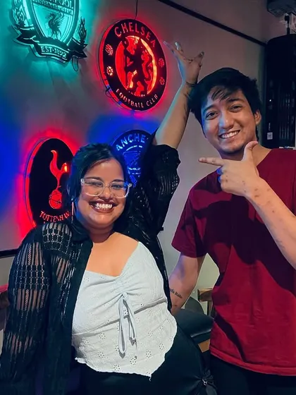 Posing in front of our wall of football club logos. Our events bring together fans of all kinds, from music to sports.