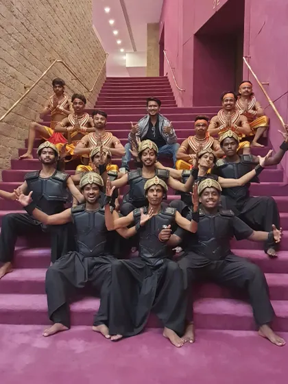 The team of dancers posing on the grand staircase of the theatre. Being part of such a massive production is a testament to our team's capability and dedication.