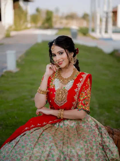 A lovely seated portrait that feels natural and relaxed. The bride's smile is infectious, and the outdoor greenery provides a beautiful backdrop for her colorful attire.
