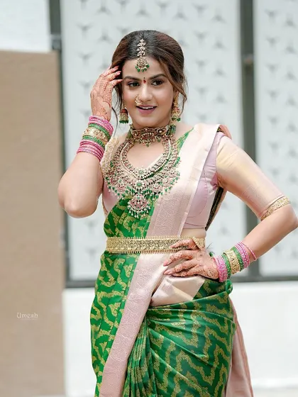 A full-length pose that captures the elegance of the saree and the grandeur of the jewellery.