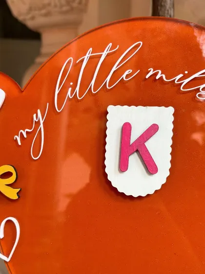 Zooming into the magic of the teddy bear milestone board. This project involved 3D cutouts, a scalloped banner with the baby's initial, and UV printing on an acrylic base, a new technique I was excited to try.