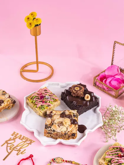 A close-up of the assorted Rakhi treats on a decorative plate, showing the variety and detail of each dessert.