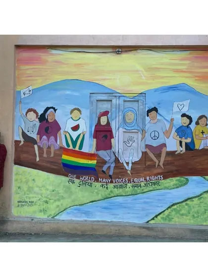 With my "One World, Many Voices, Equal Rights" mural in Pakke Kesang. This piece is a colorful prayer for a world where everyone is seen and heard.