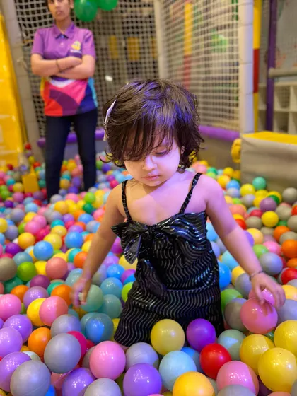 A little one exploring the vibrant colors and textures of our massive ball pit.