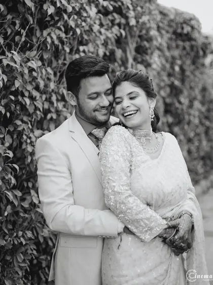 A joyful black and white photo of a couple embracing. Capturing genuine laughter is a key part of my candid photography style.