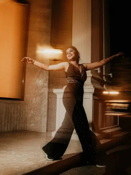 A dynamic portrait of the bride dancing, captured with a slow shutter speed. The motion blur beautifully conveys her movement and the joyful energy of the moment.