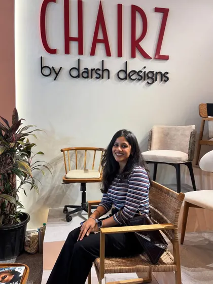 A happy visitor trying out one of our cane and wood armchairs. Thank you for stopping by during our precious moment.