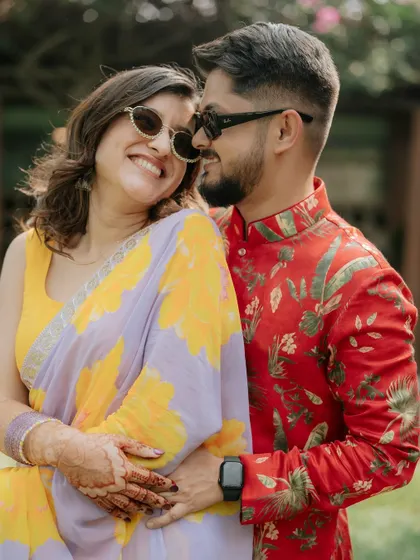 A sweet and affectionate portrait. The couple's genuine smiles and embrace show their easy chemistry.