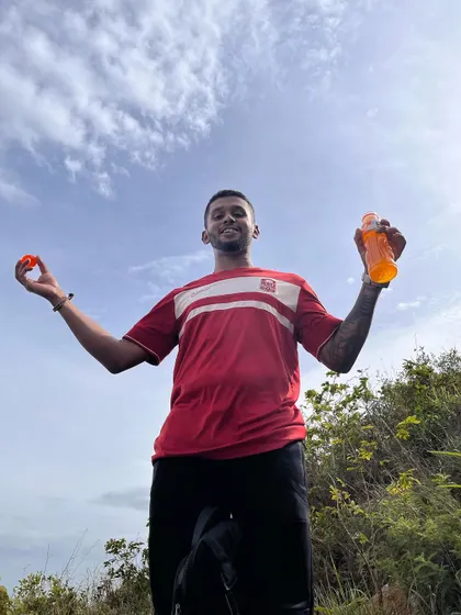 Staying hydrated and energized at the top. A little refreshment and a big smile make the perfect summit celebration.