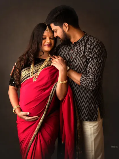 I had the absolute honor of capturing this tender moment between two renowned photographers. This traditional couple's maternity portrait, with them in a beautiful red saree and kurta, shows the deep connection and quiet joy of expecting parents.