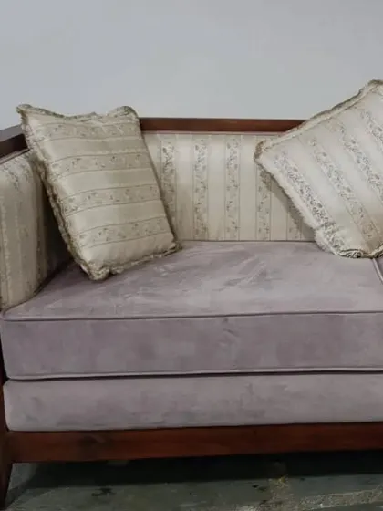 A close-up of a sofa with a solid wood frame and dual-textured upholstery. The combination of patterned back and solid seat fabric adds a layer of custom sophistication.
