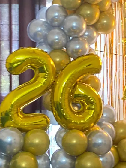 Large gold foil numbers are a great way to personalize a milestone birthday celebration.