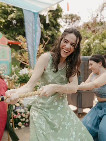More laughter and fun during the tug-of-war game at the Mehendi celebration.