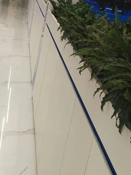 This perspective shows how our integrated planters seamlessly blend with the modern office architecture. The continuous line of greenery provides a natural element that softens the clean lines of the corridor and workspace.