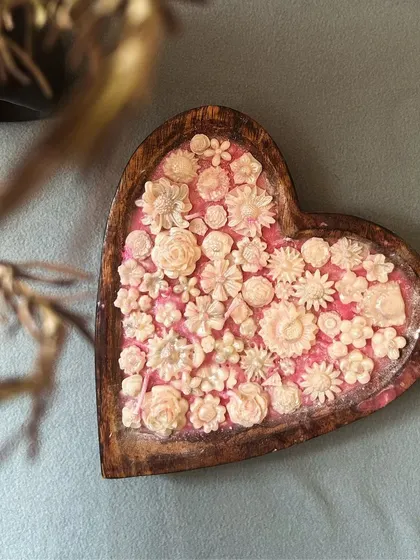A top-down view of the intricate floral details on my heart-shaped dough bowl candle.