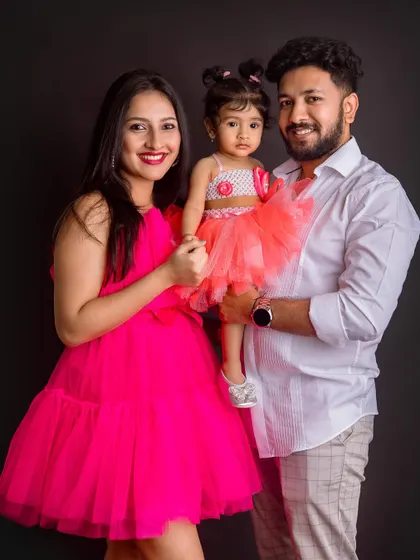 A beautiful portrait of the family smiling together. The bright outfits bring so much life and joy to this studio shot.