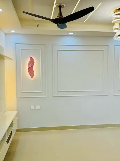 A simple yet elegant living room wall design. I used POP moulding to create classic panels and added backlit art pieces for a soft, ambient glow.