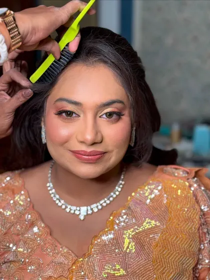 A behind-the-scenes shot of the hair and makeup process for this intricate sangeet look.