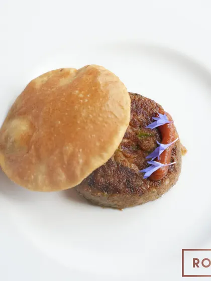A perfectly plated Shami Kabab and Poori, a dish that translates to "The Taste of the Soul" and captures the essence of Lucknowi cuisine.