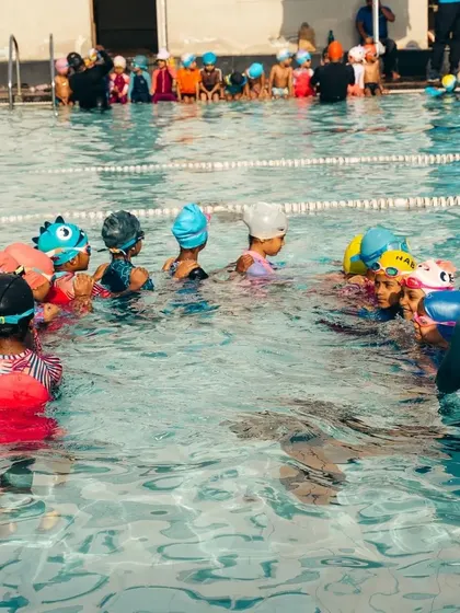 From beginners to future champions, our summer camp welcomes all. A group of students learns together under the watchful eye of a coach.