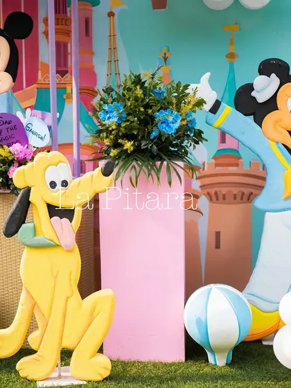 Playful cutouts of Pluto and Sailor Mickey, adding to the cheerful and colorful atmosphere of the event.