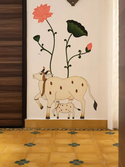 A beautiful hand-painted Pichwai mural of a cow and calf, adding a touch of traditional Indian art and spirituality to the home.