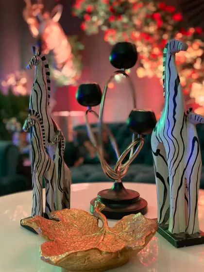 Charming giraffe figurines and other animal-themed props add a playful and whimsical touch to the sangeet decor.
